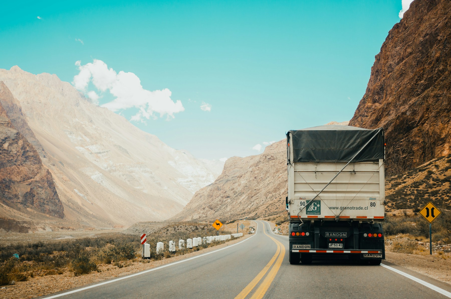 White semi-truck traveling on an open highway